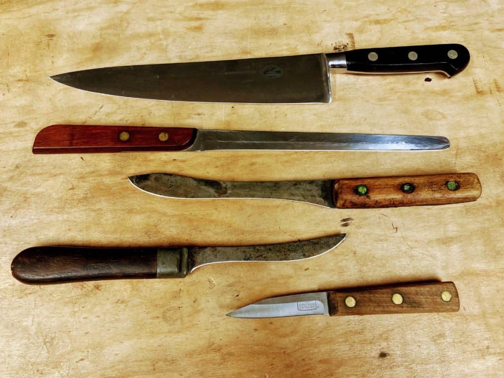 an assortment of kitchen knives freshly sharpened